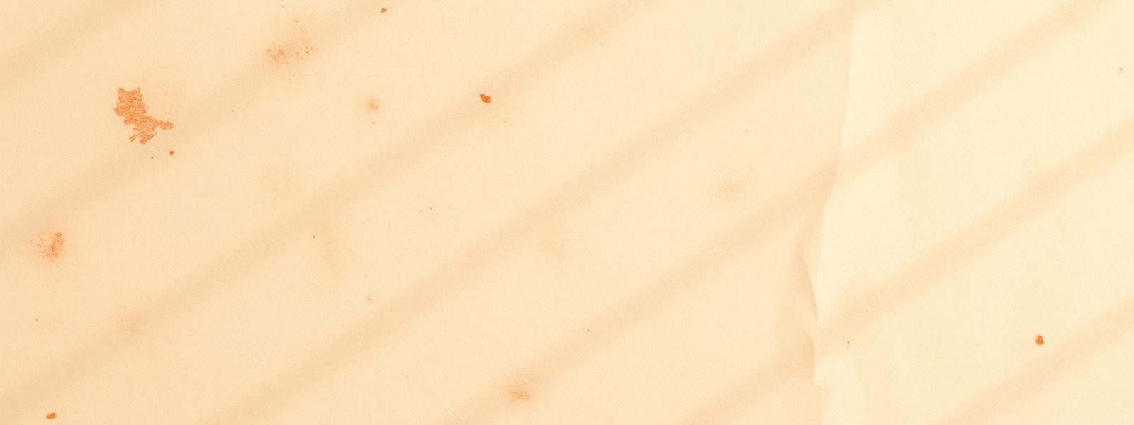 Decorative warm cream parchment texture with gold and red threads